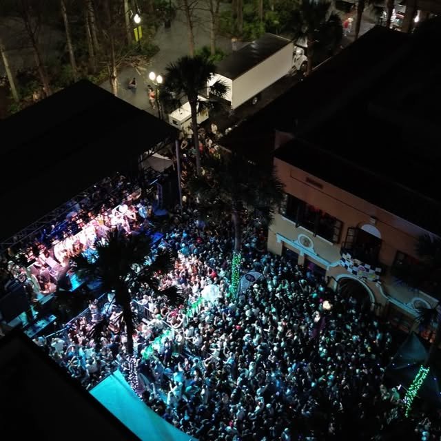 Aerial view of a packed Wall Street Plaza block party at night in Downtown Orlando