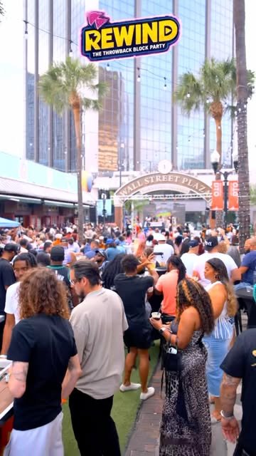 Crowd under the Wall Street Plaza arch at a Downtown Orlando block party